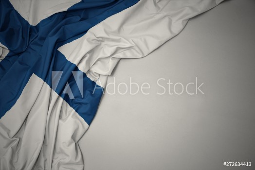 Picture of waving national flag of finland on a gray background